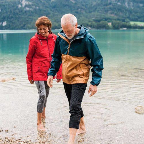 couple smiling near a river