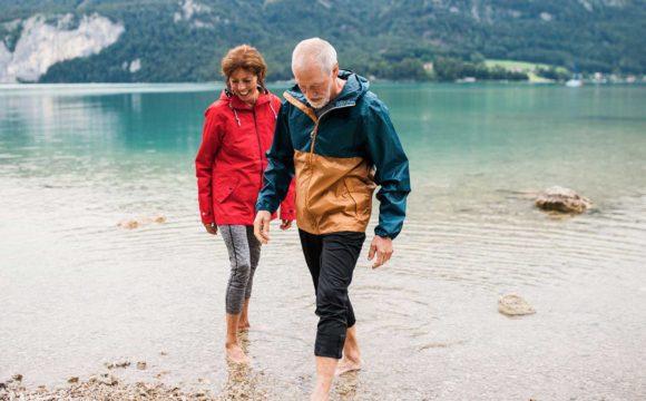 couple smiling near a river